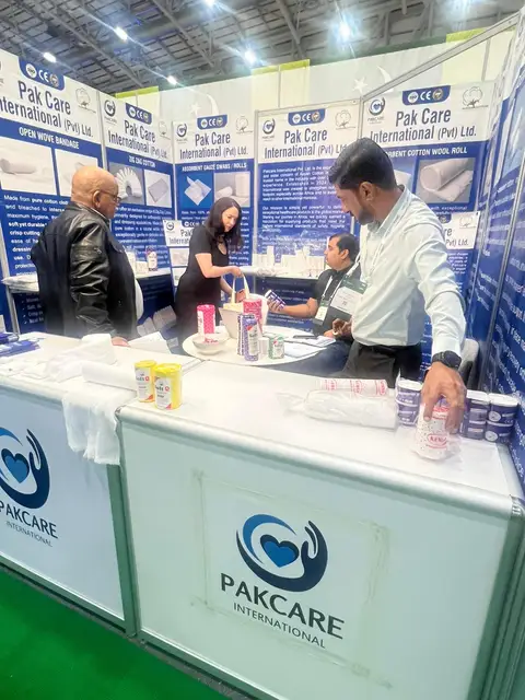 Visitors browsing SoftQ and bandage samples at the stand counter