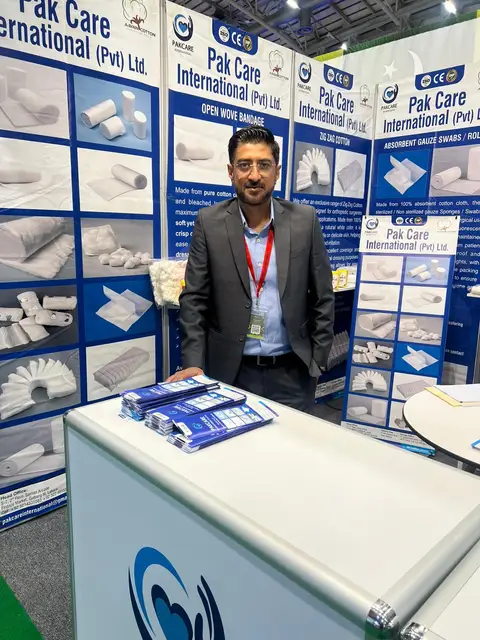 A Pak Care team member at the stand counter with brochures