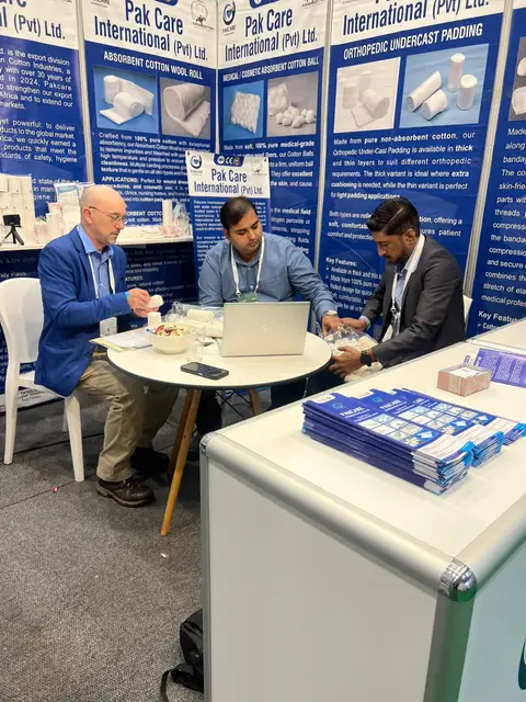 The Pak Care team and a buyer examining cotton samples at the stand