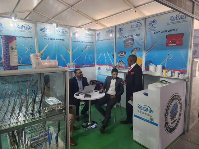 Talking with a visitor at the Zartaas Industries stand in Nairobi