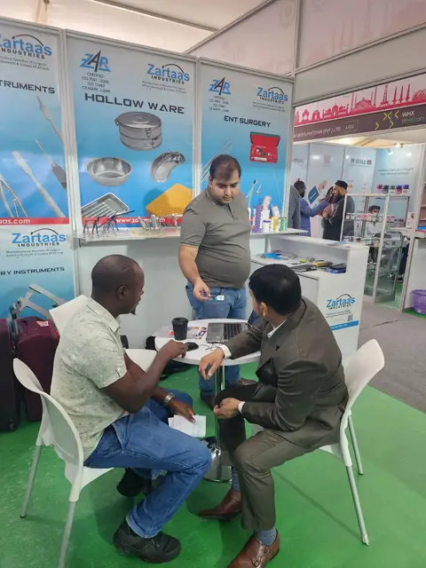 A visitor meeting the team at the stand, WHX Nairobi hall behind